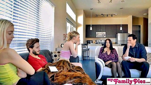 Blonde stepsisters and brunette stepmom chatting clothed with stepdads in taboo family living room