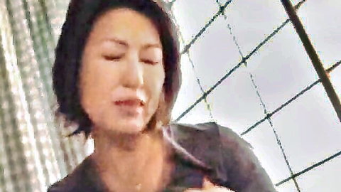 Excited Asian MILF in open gray blouse teasing cleavage
