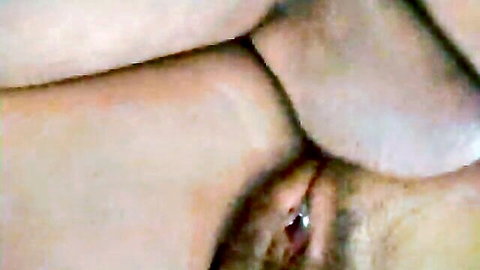 Close-up view of hairy pussy with piercing and insertion