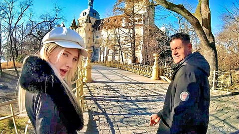 Melody Marks and stepdad outdoors by historic bridge in fur coats