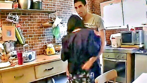 Hairy mature woman hugged by younger guy in intimate kitchen embrace