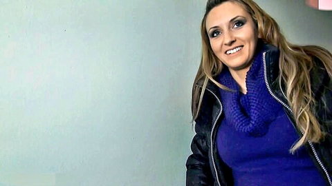 Pina Popp smiling in purple turtleneck and black leather jacket