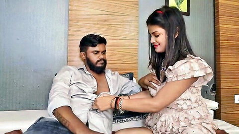 Desi Indian wife in ruffled dress touching bearded husband's arm intimately