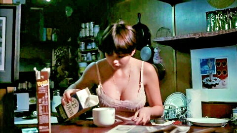 Busty brunette Nancy Hoffman in sexy lace lingerie pouring milk