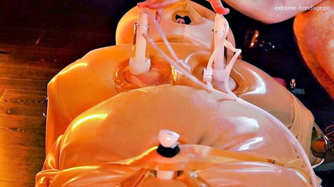 Anna Kovachenko bound in orange inflatable latex sack with tubes