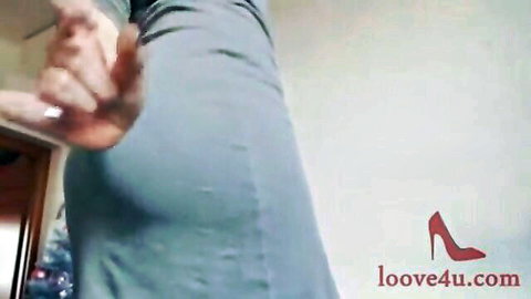 Seductive woman in tight blue jeans teasing hand on thigh