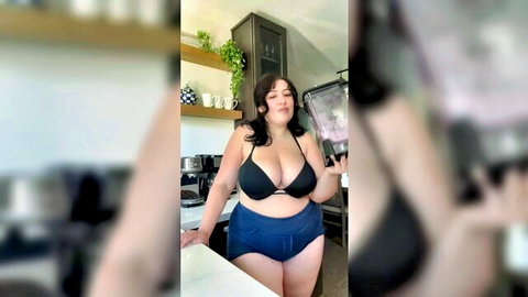 Curvy brunette BBW in black bikini top and blue bottoms posing