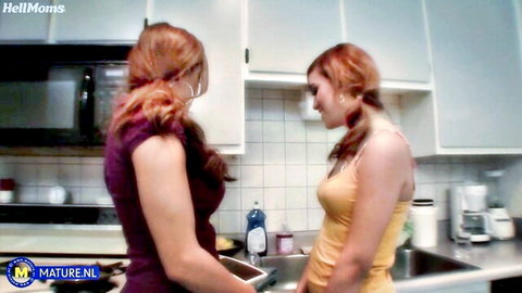 Two redhead lesbians in domestic tease, one in purple dress, one in yellow top