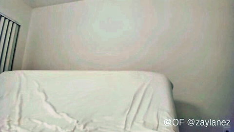 Empty cozy bedroom with white draped bed sheets and OnlyFans watermark for webcam solo setup