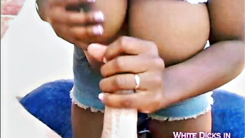 Busty black teen in denim shorts gives handjob to white cock