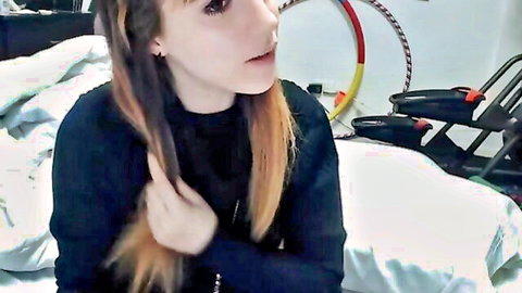 Amateur blonde webcam girl with long hair in black turtleneck posing solo