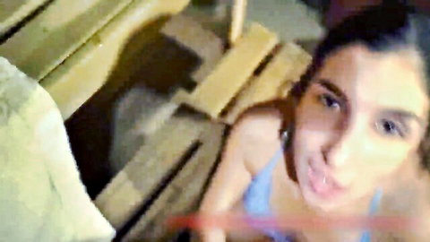 POV tease of brunette woman with dark eyes in blue tank top, mystery drop surprise