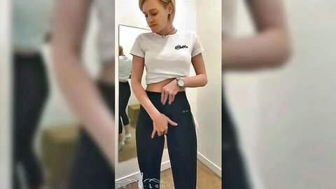 Amateur blonde in white crop top and black pants teasing mirror selfie