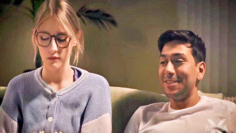 Melody Marks in glasses and sweater during cozy movie night with guy