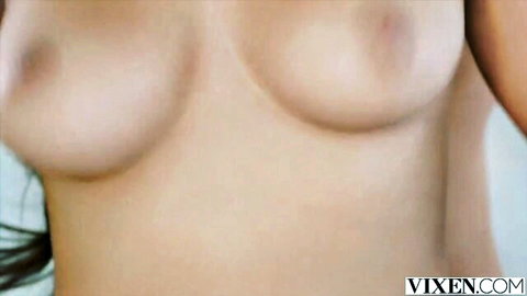 Buxom beauty with voluptuous large breasts, topless close-up