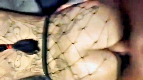 Tattooed woman in fishnet stockings and garter belt, teasing big ass close-up