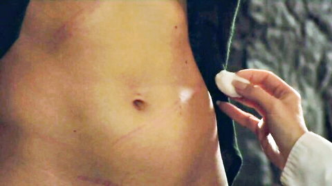 Toned male torso with scar, female hand dabbing cotton swab in BOUNDHEAT - The Story Of Nora