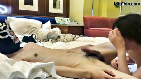 Masked Asian woman nude on bed with hand on censored pussy
