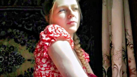 Sexy blonde village girl with braided hair in red polka-dot dress