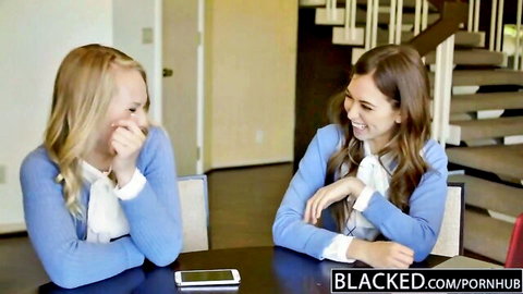 Blonde and brunette teens giggling clothed at table in Blacked interracial threesome teaser