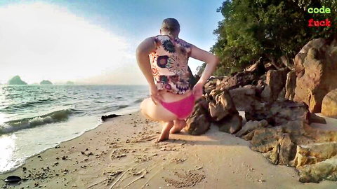 Blonde teen pulls pink bikini aside, fingering on sunny beach