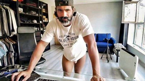 Hunky Latino man in cap and t-shirt exposing uncut erection in gay amateur solo