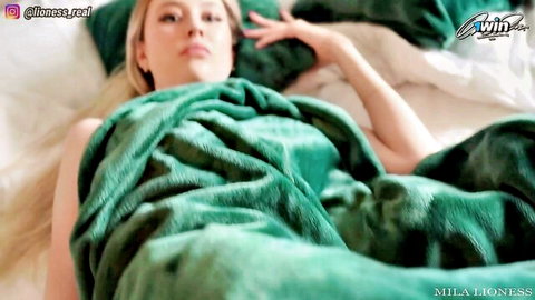 Blonde Mila Lioness wrapped in green blanket on bed, post-club tease