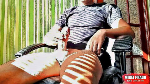 Young amateur stud strokes his big uncut cock solo while sitting in chair