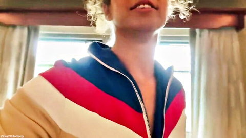 Seductive blonde MILF teases deep cleavage in colorful striped jacket with pouty lips