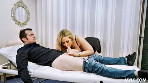 Blonde MILF doctor sucking patient's hard cock during blowjob on exam table