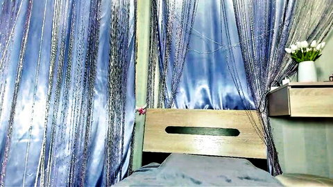 Juilionesunray's serene bedroom with blue beaded curtains and white flowers