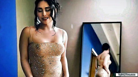 Sexy shemale in sparkly gold dress, mirror pose showing curves and ass