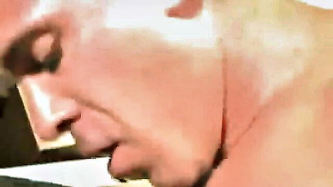 Intense close-up of muscular daddy's face in ecstasy during gay pounding