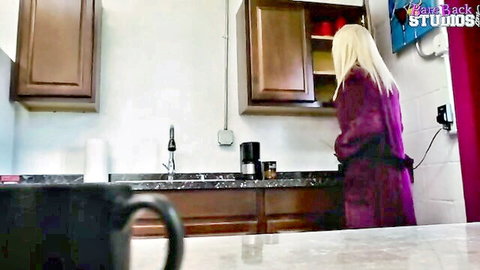 Blonde wife in purple robe teasing seductively in kitchen
