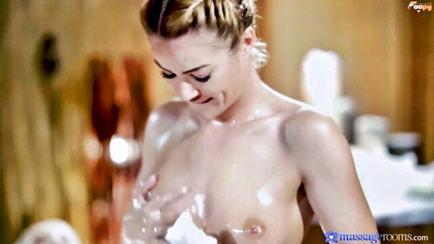 Blonde with soapy tits smiling in steamy massage room shower