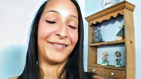 Smiling ebony woman with long dark hair, eyes closed in pleasure, from Hot Ebony Cock Whore