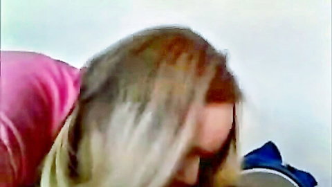 Blonde housewife in pink top side profile view