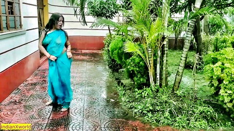 Wet South Asian MILF in sheer blue saree clinging to tits and curves outdoors