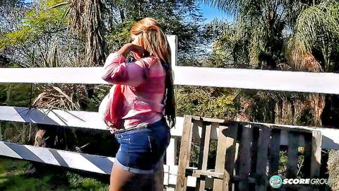 Africa Sexxx country girl in denim shorts, showing plumper curves and legs outdoors
