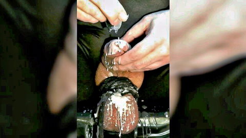 Closeup solo male urethral sounding with waxplay on erect cock in BDSM session