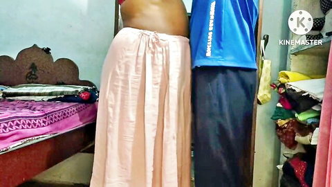 Sexy Indian wife in low-draped peach saree skirt exposing bare midriff and navel with husband in bedroom