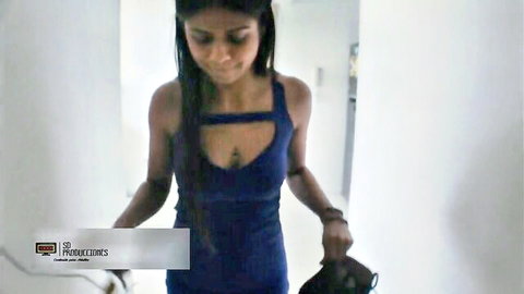 Sexy Indian woman in revealing blue cut-out dress, long hair, apartment tease