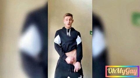 Cute blonde guy in hoodie pulls down sweatpants to tease bulge