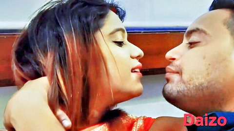 Indian couple in red saree passionately kissing and necking intimately