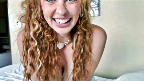 Elly Clutch redhead smiling in lace lingerie, cleavage tease