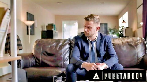 Suited DILF sits pensively on leather couch in Pure Taboo living room scene