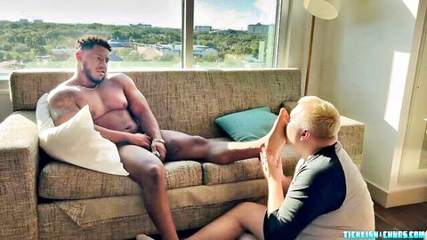 Ebony bear lounges nude as tickle master licks his foot