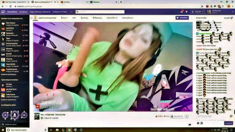 Brunette Twitch streamer holds pink dildo in green hoodie during live cam show