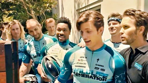 Group of athletic men in cycling jerseys posing together in Trapped Inn scene with Noemie Maia