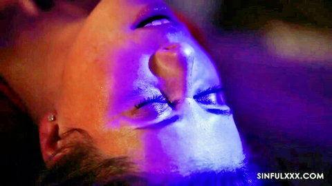 Brittany Bardot's ecstatic close-up face in blue-lit wet scene